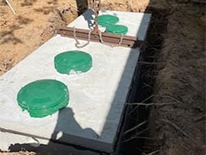 Quality septic system installation for residential and commercial properties Multiple septic tanks installed in concrete during septic system construction
