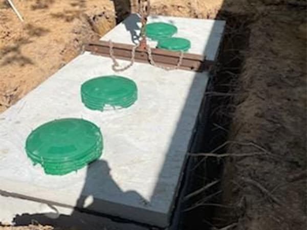 Quality septic system installation for residential and commercial properties Multiple septic tanks installed in concrete during septic system construction