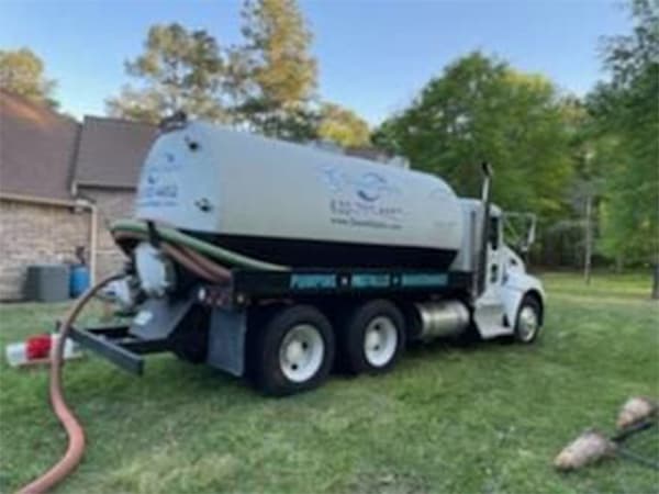 Septic tank pumping and emergency septic service in Houston Texas Septic service truck pumping residential septic tank in Houston yard
