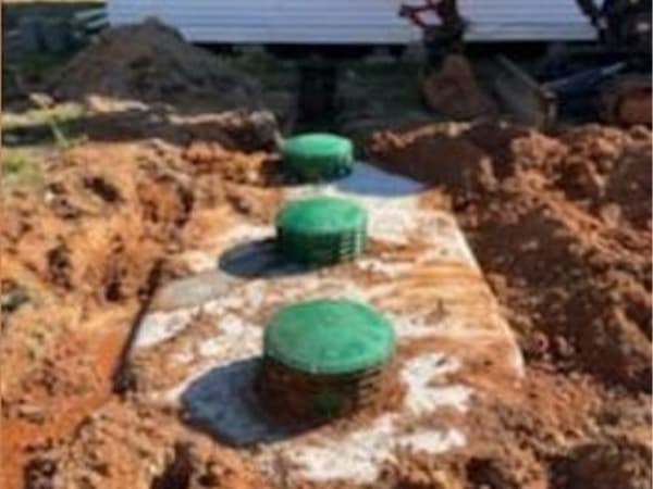 Reliable septic installation services by Sweet Septic Septic tanks being set in place as part of a new septic system installation