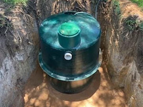 Backfilling soil around newly installed septic tank system Backfilling soil around newly installed septic tank system